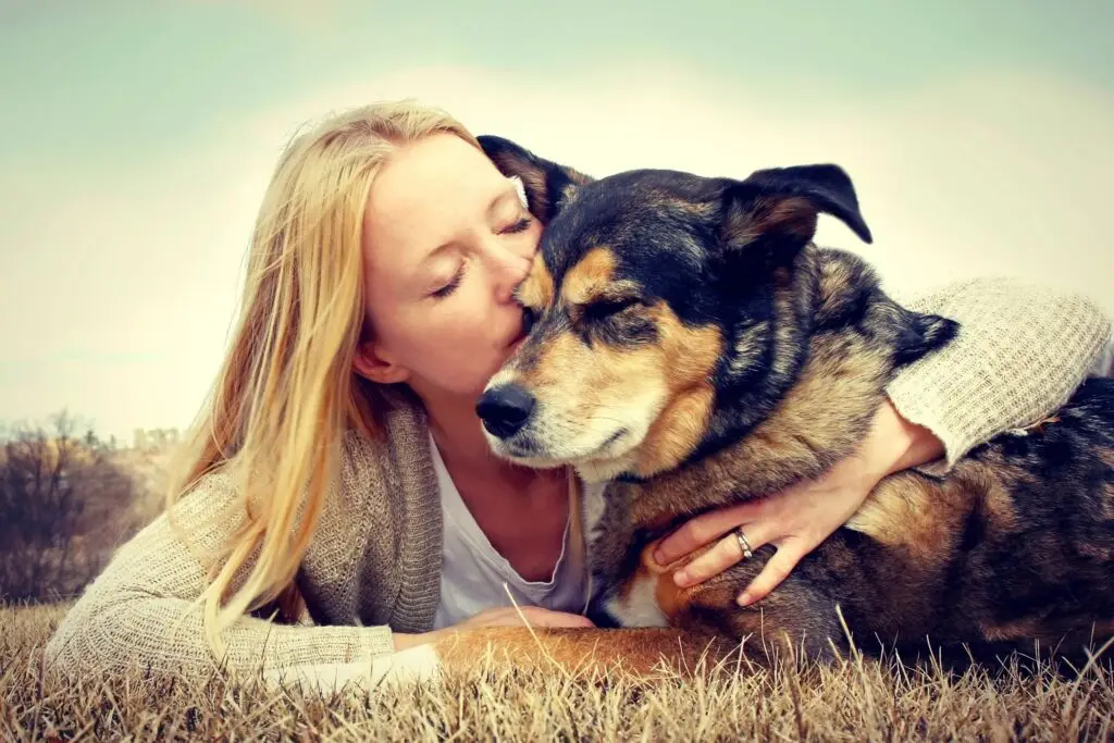 woman sitting with her dog, showing companionship and warmth.
